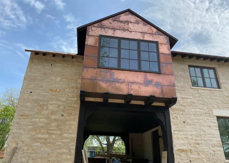 Copper metal panel facade on a stone building for Roof Repair in Redwood Falls